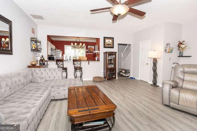 9155 Nesbit Ferry Rd Unit 96, Alpharetta, GA 30022 - living room with stairs, light wood-style floors, a ceiling fan, and a chandelier