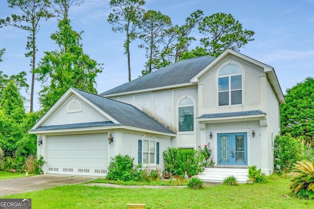 175 Palmera Ln, Brunswick, GA 31525 - view of front facade featuring french doors, a garage, driveway, and a front lawn