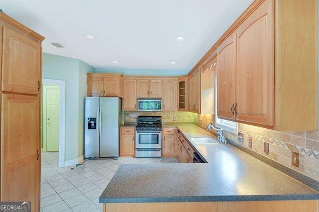 175 Palmera Ln, Brunswick, GA 31525 - kitchen featuring stainless steel appliances, light brown cabinets, a sink, light tile patterned floors, and tasteful backsplash