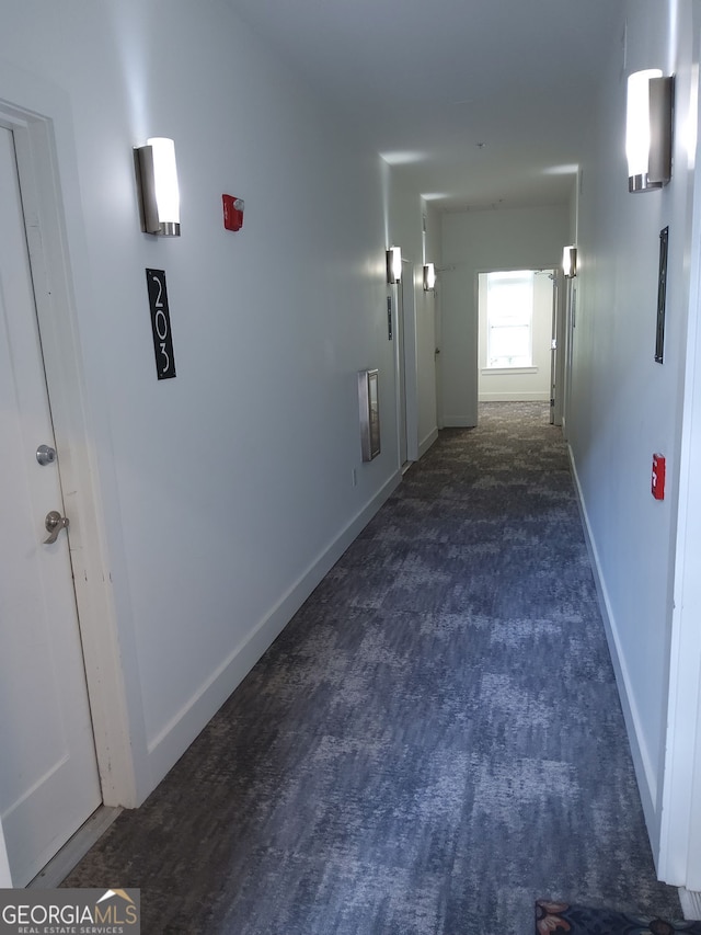 hall featuring baseboards