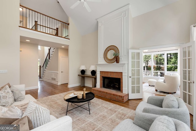 210 Wentworth Ter, Alpharetta, GA 30022 - living area with high vaulted ceiling, ceiling fan, wood finished floors, stairway, and a fireplace