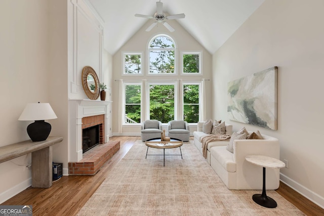 210 Wentworth Ter, Alpharetta, GA 30022 - living room featuring wood finished floors, a ceiling fan, high vaulted ceiling, a brick fireplace, and baseboards