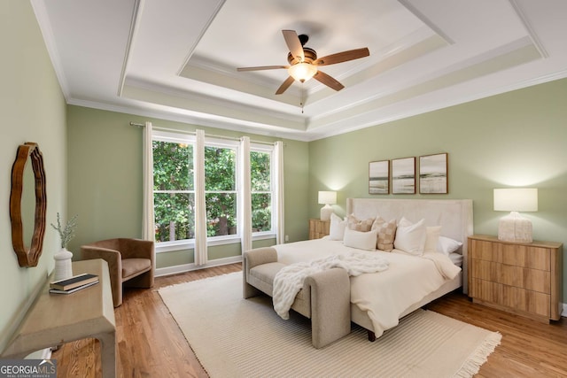 210 Wentworth Ter, Alpharetta, GA 30022 - bedroom featuring a tray ceiling, crown molding, light wood-style floors, and a ceiling fan