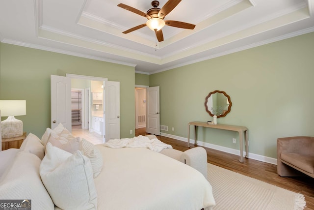 210 Wentworth Ter, Alpharetta, GA 30022 - bedroom featuring a tray ceiling, wood finished floors, crown molding, ensuite bath, and ceiling fan
