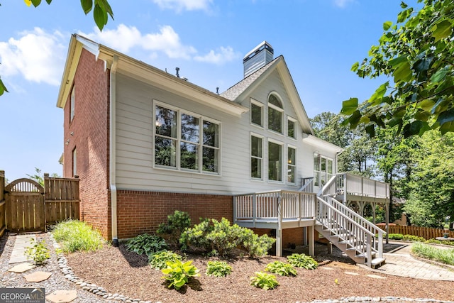210 Wentworth Ter, Alpharetta, GA 30022 - view of home's exterior featuring brick siding, a deck, stairs, and a chimney