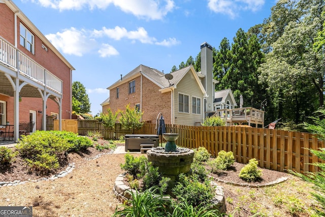 210 Wentworth Ter, Alpharetta, GA 30022 - rear view of property featuring a fenced backyard, brick siding, and a hot tub