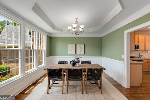 210 Wentworth Ter, Alpharetta, GA 30022 - dining room featuring plenty of natural light, wood finished floors, a chandelier, ornamental molding, and a tray ceiling