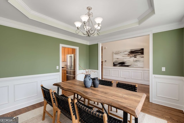 210 Wentworth Ter, Alpharetta, GA 30022 - dining area with a chandelier, a wainscoted wall, crown molding, wood finished floors, and a tray ceiling