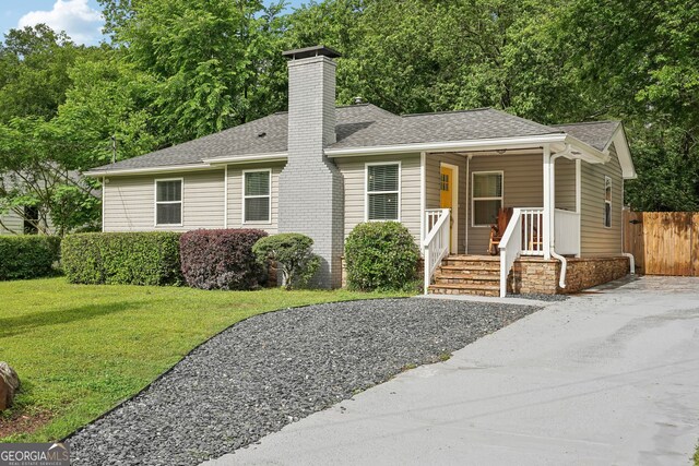 1605 Wellswood Dr SE, Atlanta, GA 30315 - ranch-style house with roof with shingles, a chimney, and covered porch