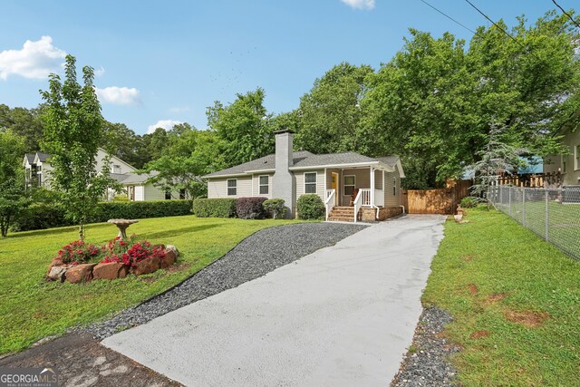 1605 Wellswood Dr SE, Atlanta, GA 30315 - view of front facade featuring a chimney, driveway, and covered porch