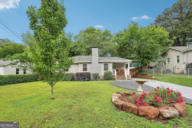1605 Wellswood Dr SE, Atlanta, GA 30315 - view of front facade featuring a chimney, covered porch, and central AC unit