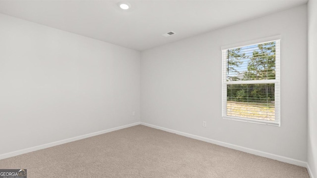 unfurnished room featuring light colored carpet, baseboards, and recessed lighting
