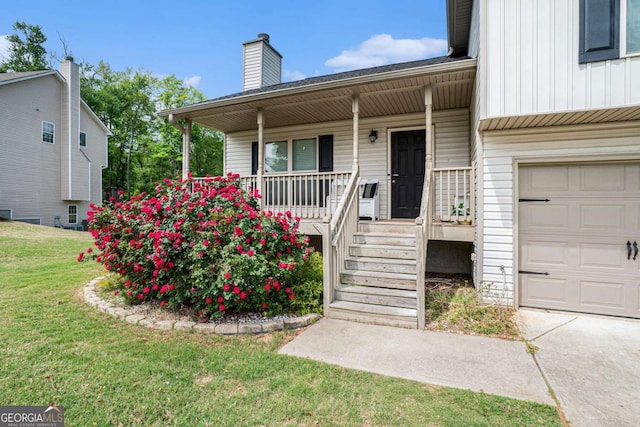 1605 Deer Creek Ln, Monroe, GA 30655 - entrance to property with a porch, board and batten siding, a lawn, a chimney, and a garage