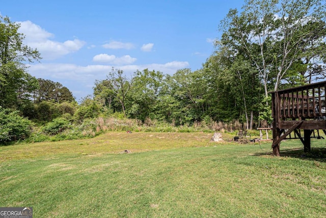 1605 Deer Creek Ln, Monroe, GA 30655 - view of green lawn with a wooden deck