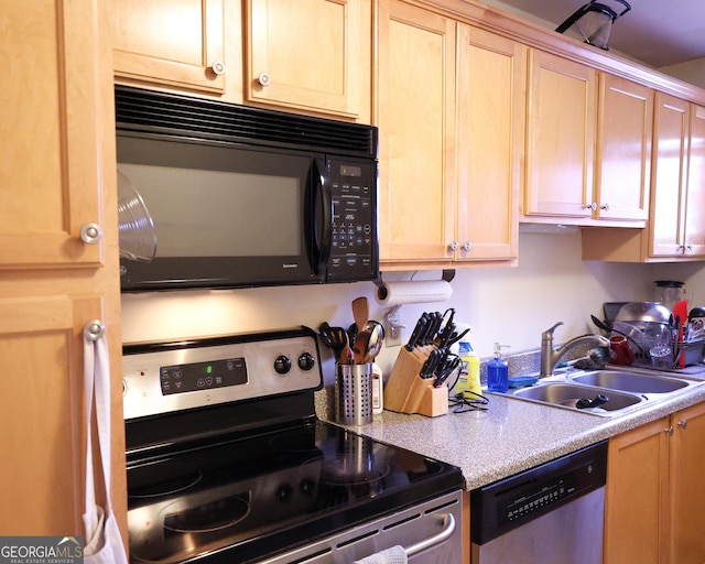 kitchen with stainless steel appliances, a sink, light countertops, and light brown cabinetry