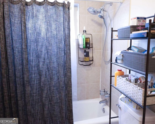 bathroom featuring shower / bath combo with shower curtain and toilet