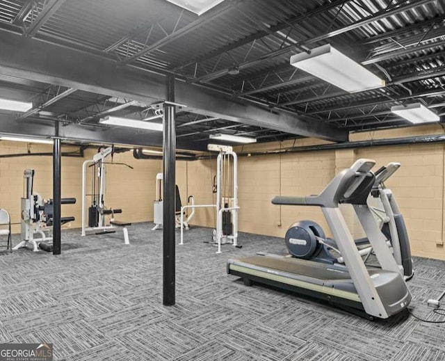 exercise area featuring concrete block wall