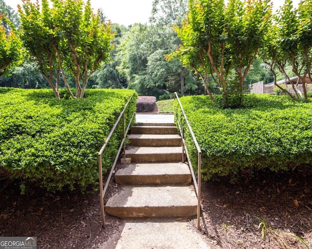 view of yard featuring fence and stairway