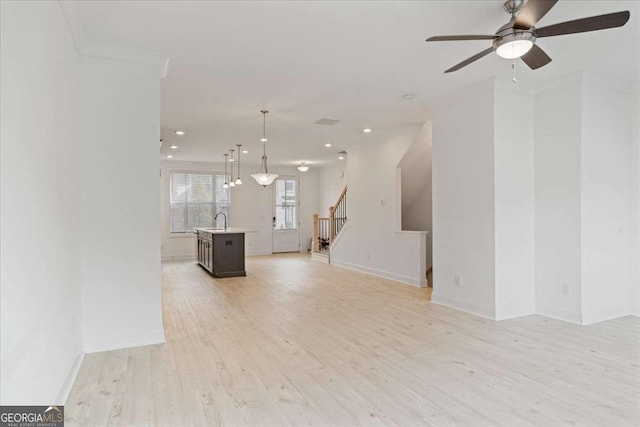 1309 Bennett Creek Ovlk, Suwanee, GA 30024 - unfurnished living room featuring stairs, light wood-style floors, ceiling fan, recessed lighting, and baseboards