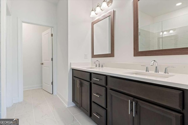 1309 Bennett Creek Ovlk, Suwanee, GA 30024 - bathroom featuring marble look tiles, double vanity, a tile shower, and baseboards