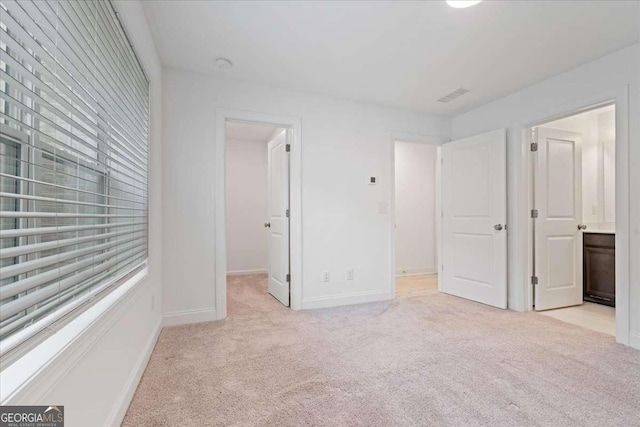 1309 Bennett Creek Ovlk, Suwanee, GA 30024 - unfurnished bedroom featuring light carpet, a spacious closet, and connected bathroom