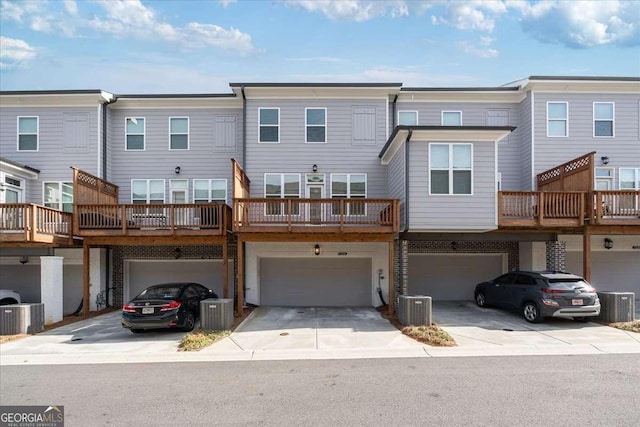 1309 Bennett Creek Ovlk, Suwanee, GA 30024 - back of house with driveway, an attached garage, and cooling unit
