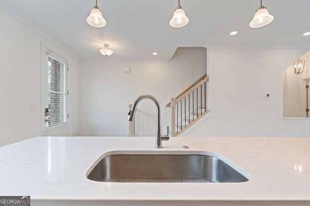 1309 Bennett Creek Ovlk, Suwanee, GA 30024 - kitchen with a sink, light stone countertops, crown molding, hanging light fixtures, and recessed lighting
