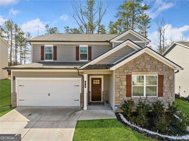 179 Leyland Xing, Dallas, GA 30132 - view of front facade with stone siding, driveway, an attached garage, roof with shingles, and a front yard