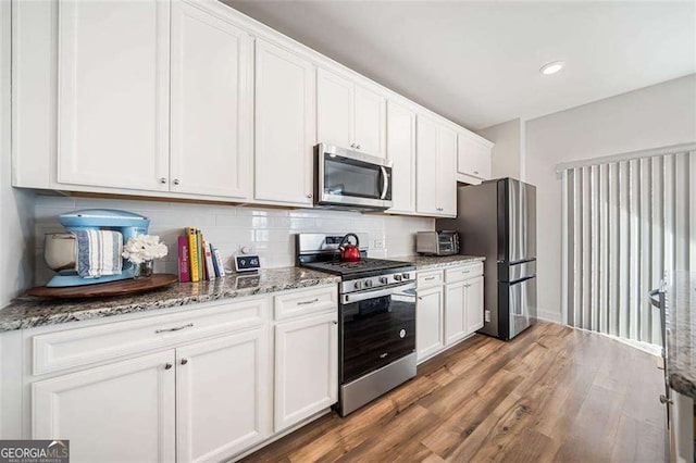 179 Leyland Xing, Dallas, GA 30132 - kitchen featuring stainless steel appliances, white cabinetry, wood finished floors, and recessed lighting
