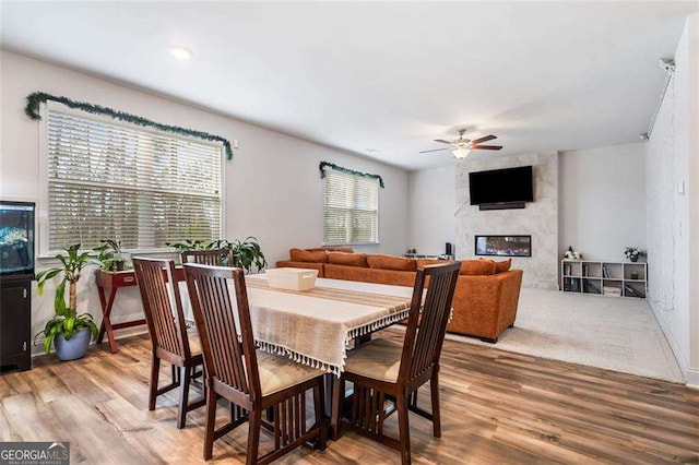 179 Leyland Xing, Dallas, GA 30132 - dining room featuring a ceiling fan, light wood-type flooring, and a large fireplace