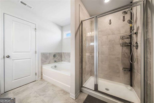 179 Leyland Xing, Dallas, GA 30132 - bathroom featuring a bath, a shower stall, and tile patterned flooring