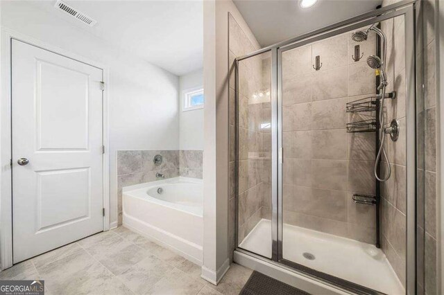 179 Leyland Xing, Dallas, GA 30132 - full bath featuring a shower stall, a bath, and tile patterned floors