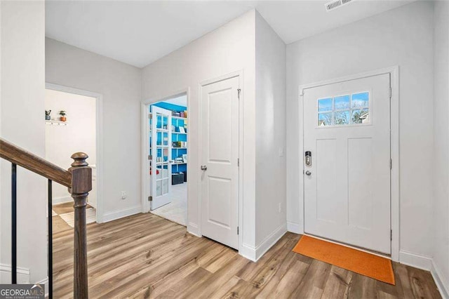 179 Leyland Xing, Dallas, GA 30132 - foyer entrance with light wood finished floors, baseboards, and stairs
