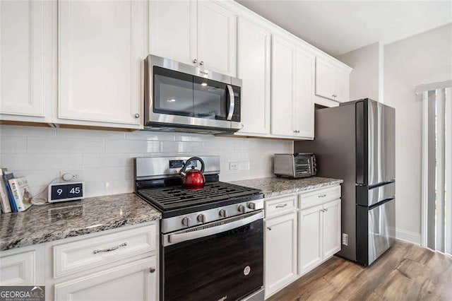 179 Leyland Xing, Dallas, GA 30132 - kitchen with appliances with stainless steel finishes, white cabinetry, and tasteful backsplash