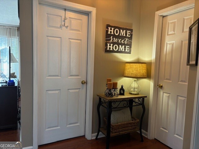 486 Village Cir, Stockbridge, GA 30281 - doorway to outside featuring dark wood-type flooring and baseboards