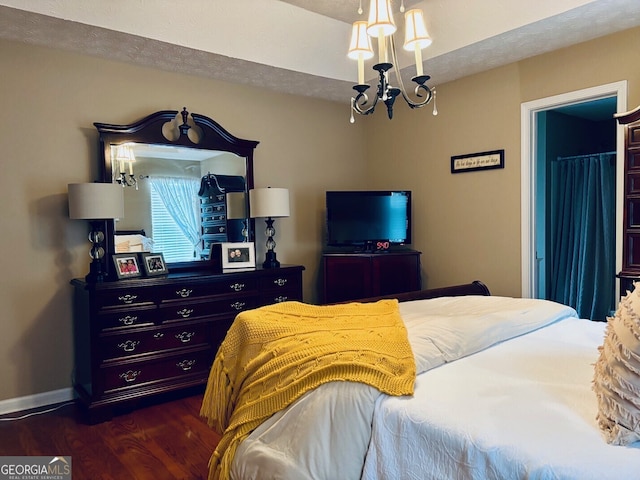 486 Village Cir, Stockbridge, GA 30281 - bedroom with dark wood-style flooring, a chandelier, and baseboards
