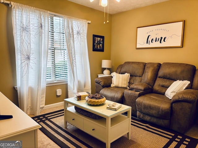 486 Village Cir, Stockbridge, GA 30281 - carpeted living area with a ceiling fan and baseboards