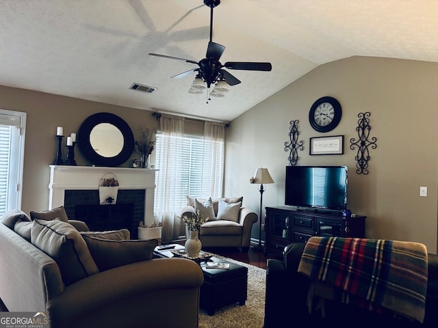 486 Village Cir, Stockbridge, GA 30281 - living room featuring ceiling fan, vaulted ceiling, wood finished floors, and a fireplace