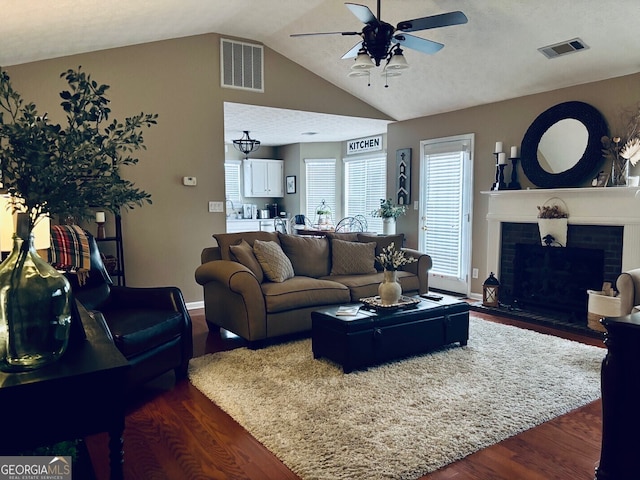 486 Village Cir, Stockbridge, GA 30281 - living area featuring dark wood-style floors, ceiling fan, lofted ceiling, a fireplace, and baseboards