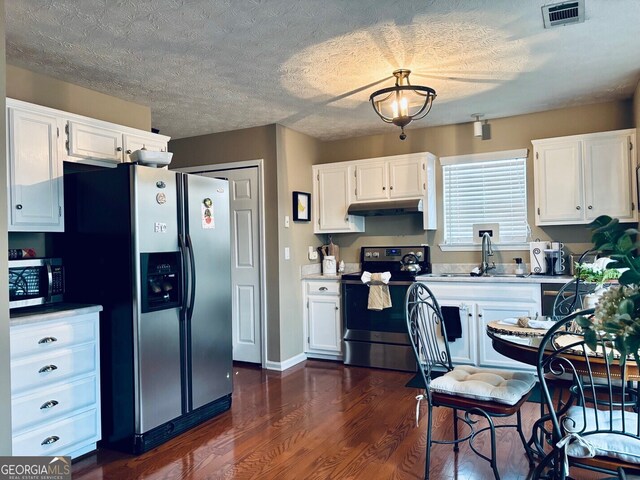 486 Village Cir, Stockbridge, GA 30281 - kitchen featuring stainless steel appliances, a sink, white cabinets, under cabinet range hood, and dark wood-style floors