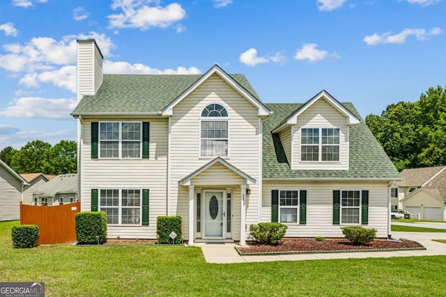view of front of home featuring a chimney and a shingled roof