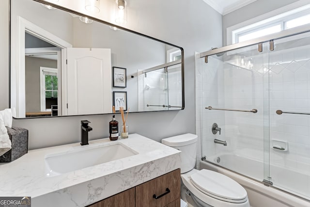 full bath with vanity, healthy amount of natural light, toilet, enclosed tub / shower combo, and ornamental molding