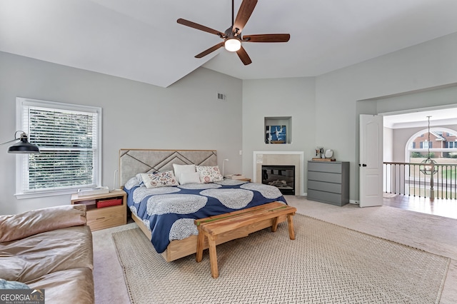 bedroom with lofted ceiling, carpet, and a ceiling fan