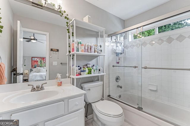 full bath with ensuite bathroom, ceiling fan, combined bath / shower with glass door, toilet, and vanity