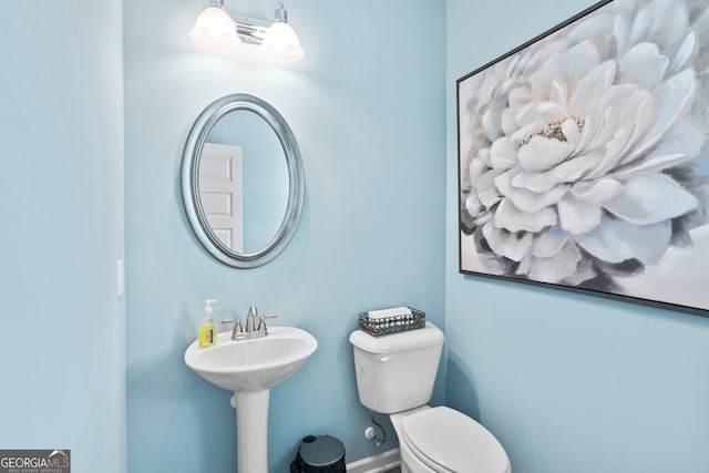 bathroom with toilet and a sink