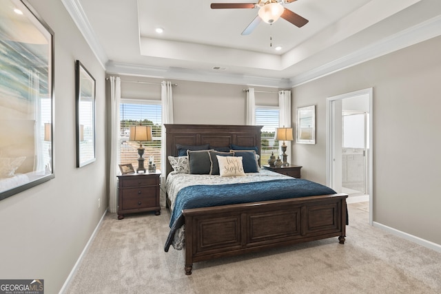 bedroom featuring light colored carpet, baseboards, recessed lighting, a raised ceiling, and ensuite bathroom