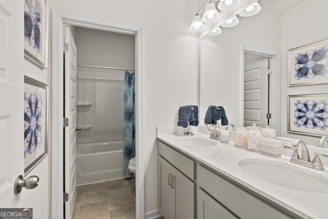 full bathroom with double vanity, shower / tub combo, and toilet
