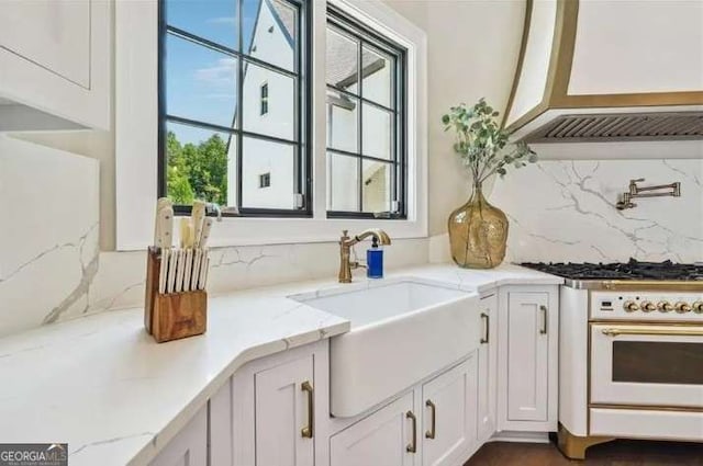 2242 Shoal Creek Rd, Buford, GA 30518 - kitchen featuring a sink, oven, white cabinetry, backsplash, and light stone countertops