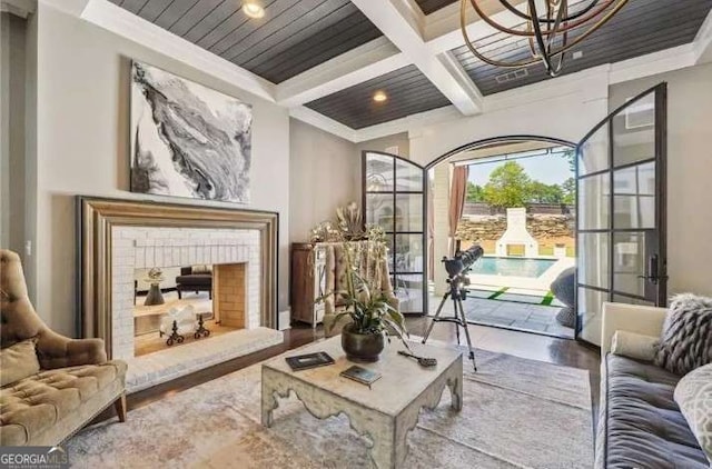 2242 Shoal Creek Rd, Buford, GA 30518 - living area featuring coffered ceiling, wood finished floors, beam ceiling, ornamental molding, and a fireplace