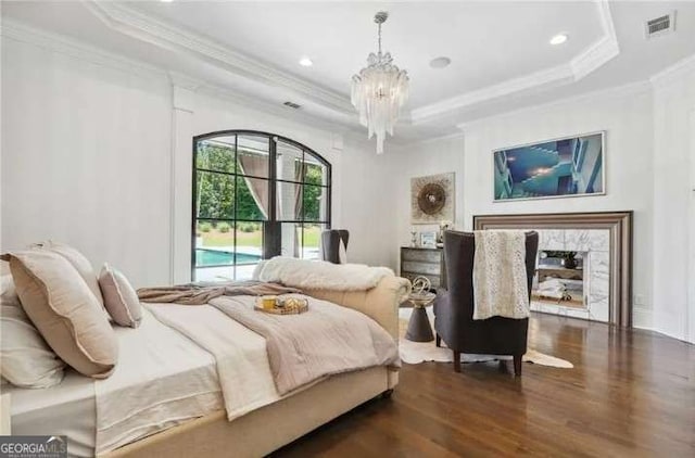 2242 Shoal Creek Rd, Buford, GA 30518 - bedroom featuring a tray ceiling, crown molding, dark wood-style flooring, a chandelier, and recessed lighting